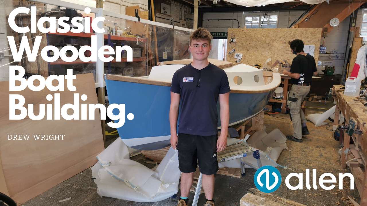 Drew Wright standign in front of this hand made plywood cabin cruiser.