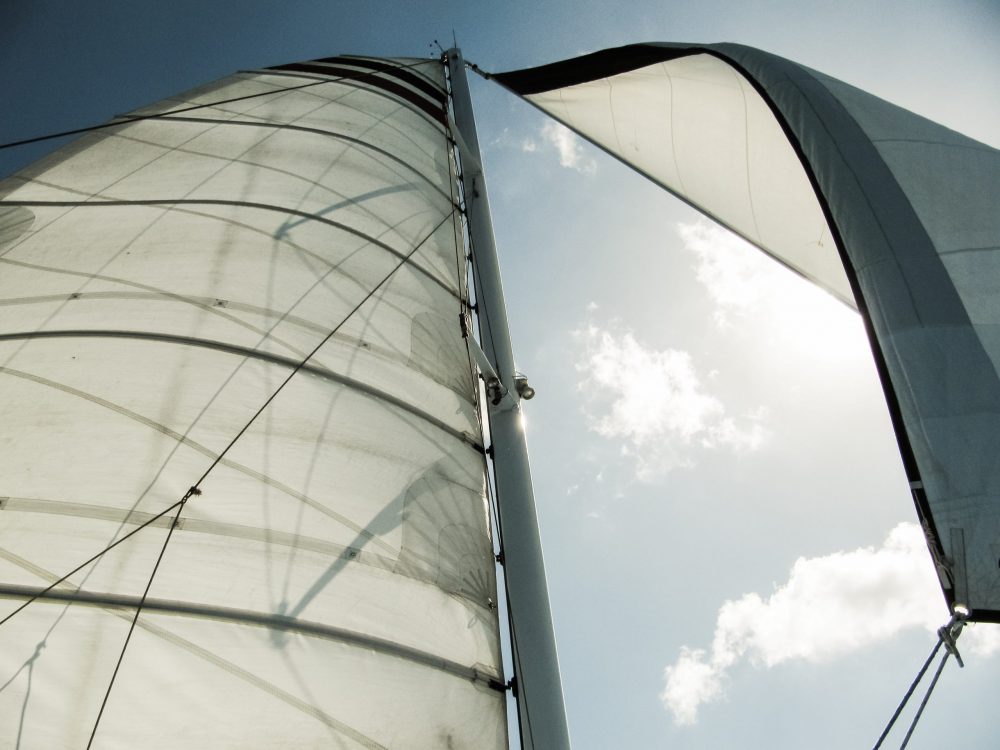 Yacht mast with sail and sail slides